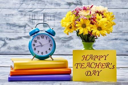 70982466-flowers-notebooks-timer-and-card-beautiful-surprise-to-teachers-day-